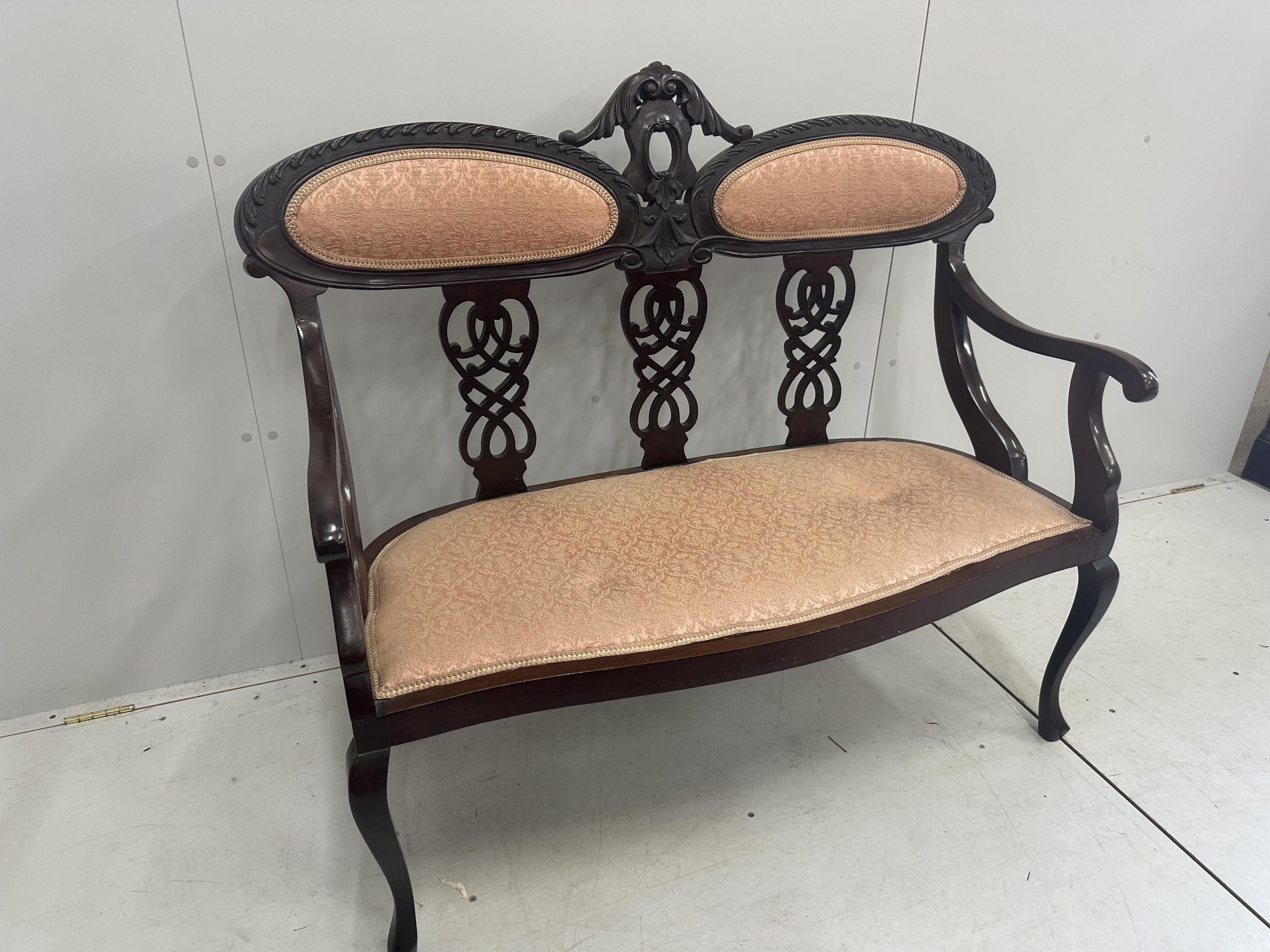 A late Victorian carved mahogany seven piece salon suite, settee width 120cm, depth 50cm, height 105cm. Condition - fair to good